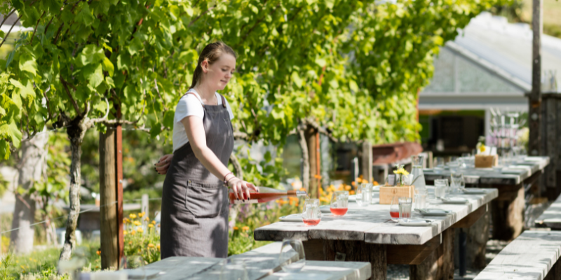 A women pouring wine at Brick Bay