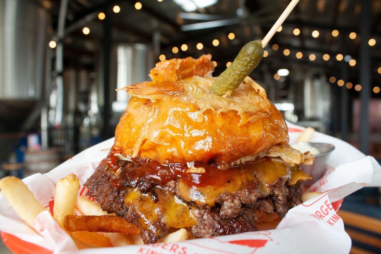 Burger with fries and a pickle on top
