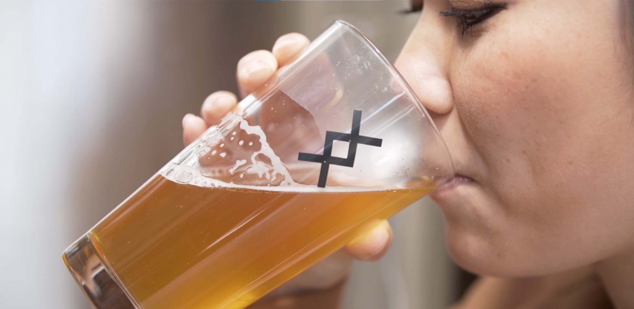 Woman drinking glass of kombucha