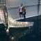 A couple observe the Crystal Waka at Auckland Art Gallery