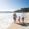 Family walking on Onetangi Beach in Waiheke Island