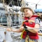 Kid raising the mainsail on a boat
