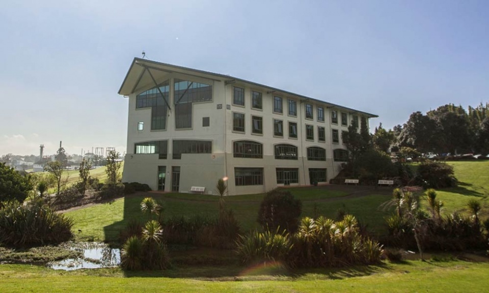 Large building surrounded by grass and trees