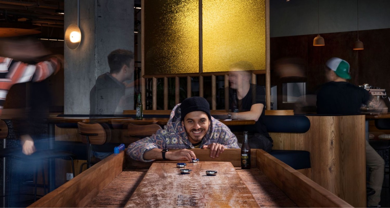A man playing Shuffleboard at LyLo Miss Lucy's