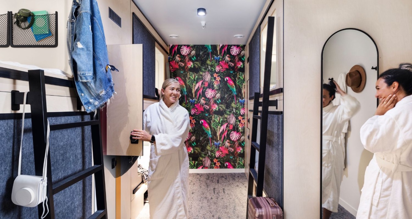 Two women chatting in a private female-only pod room