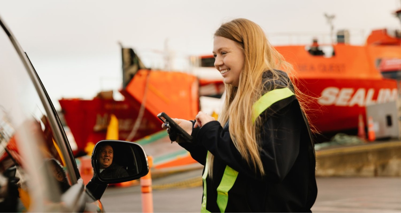 SeaLink employee talking to a customer driving onto the ferry