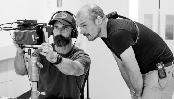 Two people on film set with camera